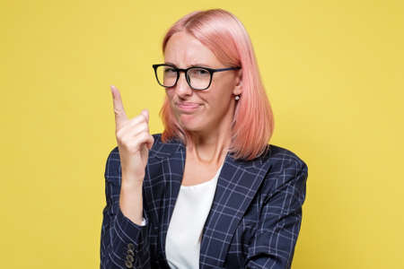 Caucasian young businesswoman holding up finger arguing with coworker.の写真素材