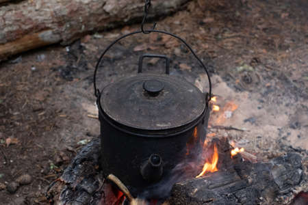Cooking in a pot on the fire during hiking.の写真素材