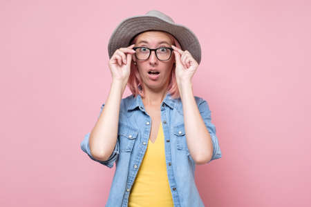 Excited caucasian woman wearing glasses looking at camera with surprise making funny face.の素材 [FY310155820121]