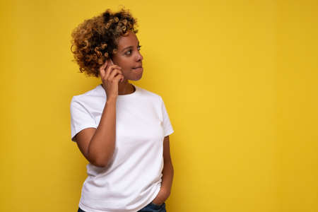 Portrait Of african american woman talking on phone listening to news seriously.の写真素材
