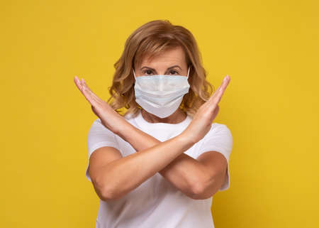 woman wearing face protection in prevention for coronavirus showing gesture Stop Infection