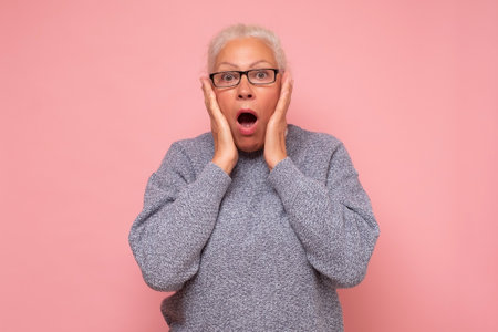 Stressed surprised old mature woman looking at camera worried about facial wrinkles.の写真素材