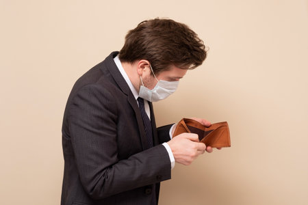 Businessman showing empty wallet having no money. I lost all my savings.