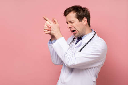 Male doctor makes a pointing finger gesture,