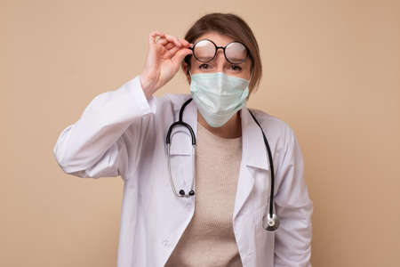 Young female doctor in medical mask. Protection against virus.の写真素材
