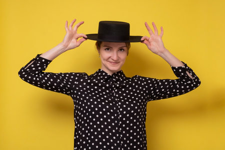 Caucasian woman in black hat with smile looking at camera. Positive emotions and beauty concept