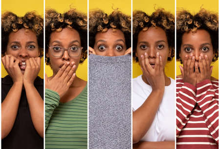 Young african curly woman being shocked, covering mouth. Latest gossip concept.の写真素材