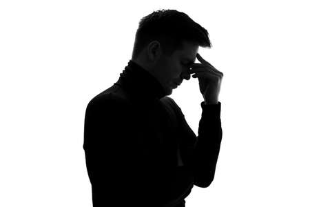Silhouette of businessman considers his options, thinking about important project.の写真素材