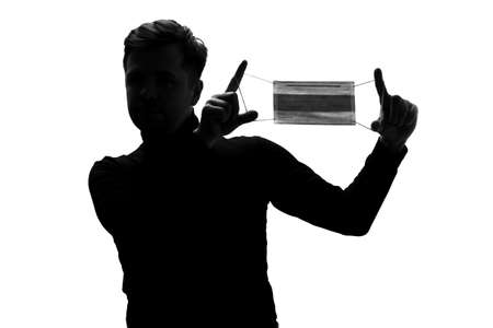 Silhouette of man with medical mask. Protection against coronavirus.の写真素材