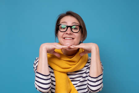 Happy attractive woman in glasses smiling and looking at cameraの写真素材