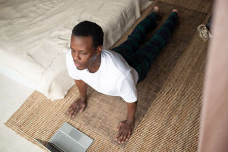 man working out, yoga, pilates, fitness training, exercises for flexible spine, urdhva mukha...