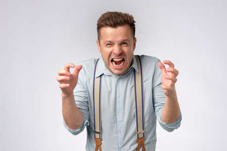 Angry man reacting furious, clenching teeth and hands.の写真素材