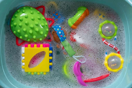 Washing plastic kids toys from microbes and dirtの写真素材