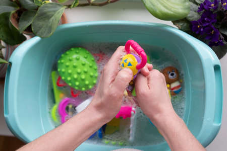 Washing plastic kids toys from microbes and dirtの写真素材