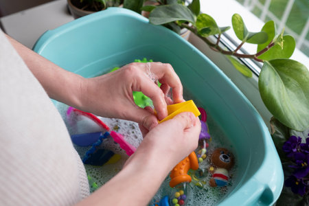 Washing plastic kids toys from microbes and dirtの写真素材