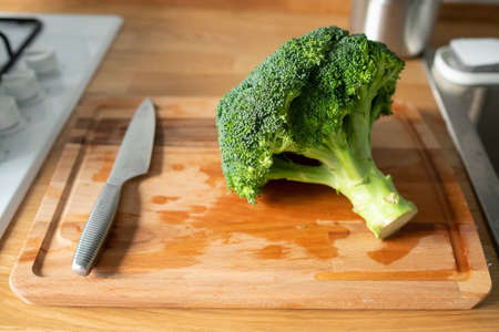 fresh green broccoli on a chopping boardの写真素材