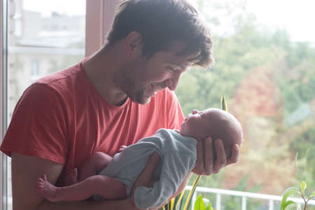 Young father and newborn baby girl spending time togetherの写真素材