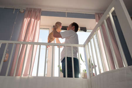 Young father and newborn baby girl playing togetheの写真素材