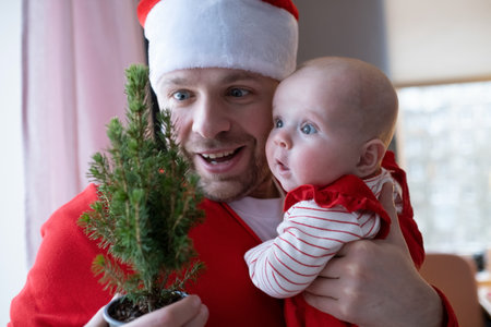 cute child and her father with christmas tree.
