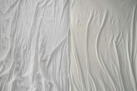 Crumpled used sheets on the bed. View from above.