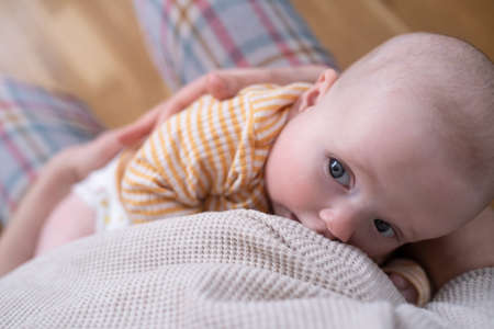 Funny caucasian baby lying on the bed.の写真素材