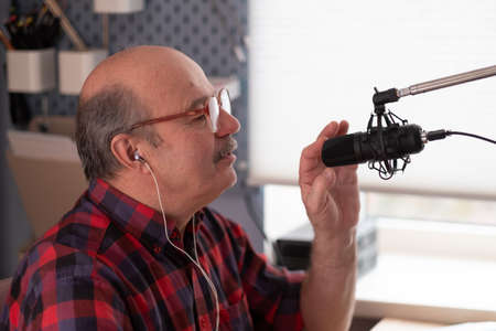 Senior businessman motivation speaker using video camera making videoの写真素材