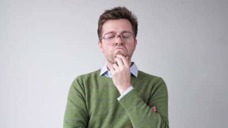 man in big glasses trying to make a decision and solve problem.の写真素材