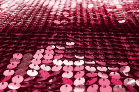 Holiday background from colored glitter paillettes, close up.の写真素材