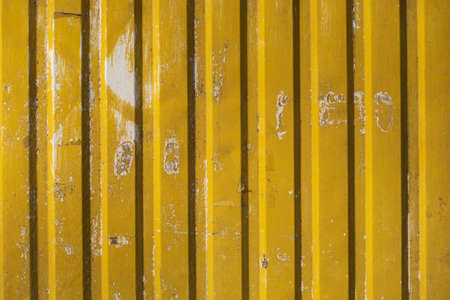 Old dirty metall yellow fence.