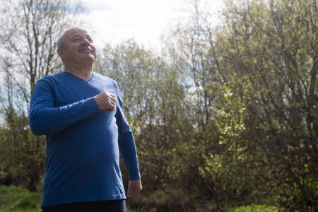 Active senior man is jogging breathing fresh air. Healthy lifestyle retirement.
