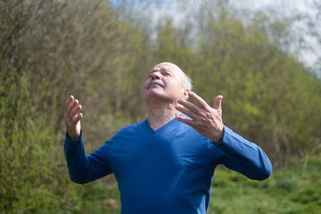 Senior runner with armband doing stretching. Spring nature.の写真素材