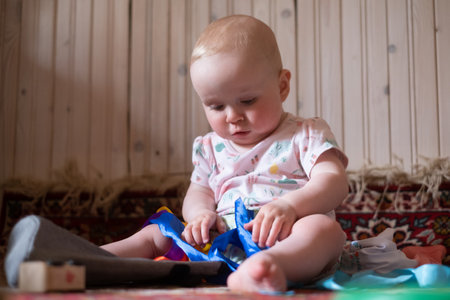 baby girl playing with toys at home
