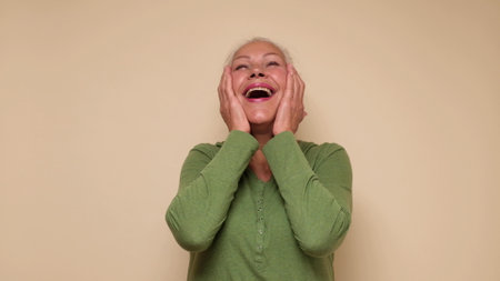An elderly European woman is laughing. studio shotの写真素材