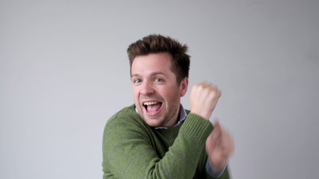 European young man dancing happily. studio shotの写真素材