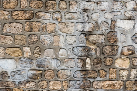 Pattern gray color of modern style design decorative uneven cracked real stone wall surfaceの写真素材