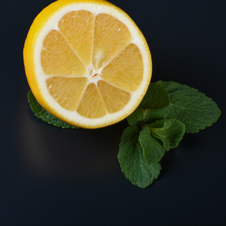 still life of fresh fruits and herbs on a dark background close upの写真素材