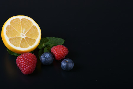 still life of fresh fruits and herbs on a dark background close up