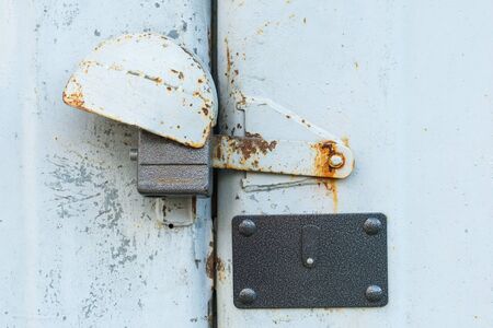 aged rusted metall gate closed steel old padlock for  safetyの写真素材