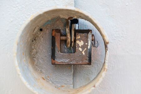 aged rusted metall gate closed steel old padlock for  safetyの写真素材