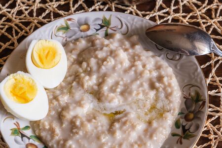 morning breakfast kitchen fresh natural food oatmeal and boiled eggの写真素材