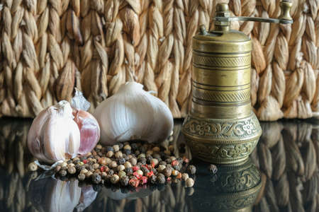 pepper granules black ground garlic mill reflected from a mirror surfaceの写真素材