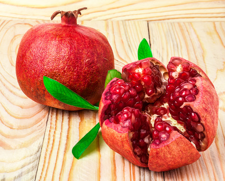 two pomegranates on wooden backgroundの写真素材
