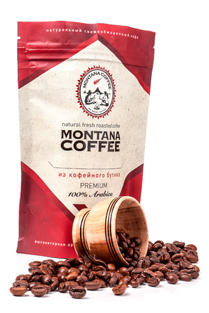 Spilled coffee beans from bowl on the white background. Ukraine.のeditorial素材