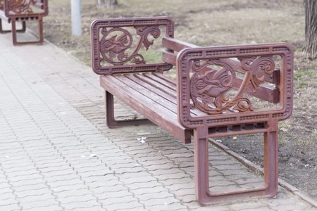 Bench in the park with vintage armrest.の写真素材