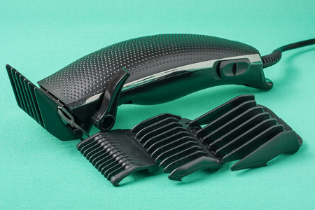 black hair clipper placed on green background.の写真素材