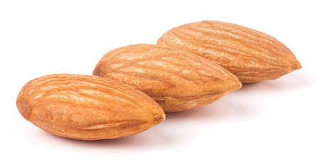 Three almonds isolated on white background macro.の写真素材