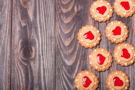 cookies with jelly on a dark wooden background.