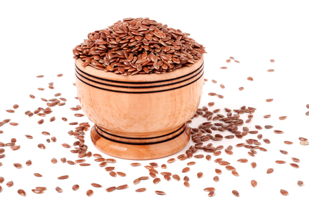 flax in a wooden barrel isolated on white background.の写真素材