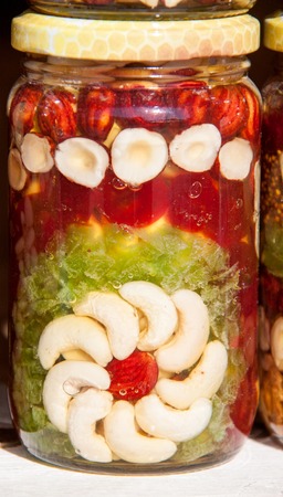 Homemade honey with dried fruits and nuts on the market.