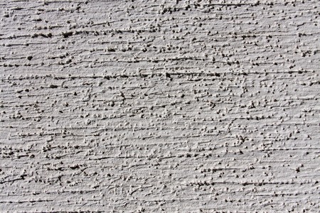 grey wall with decorative plaster as a background.